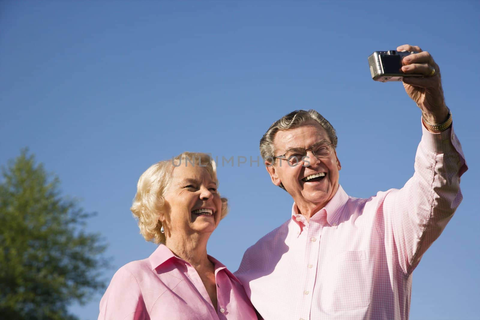 Mature Caucasian couple taking picture of themselves.