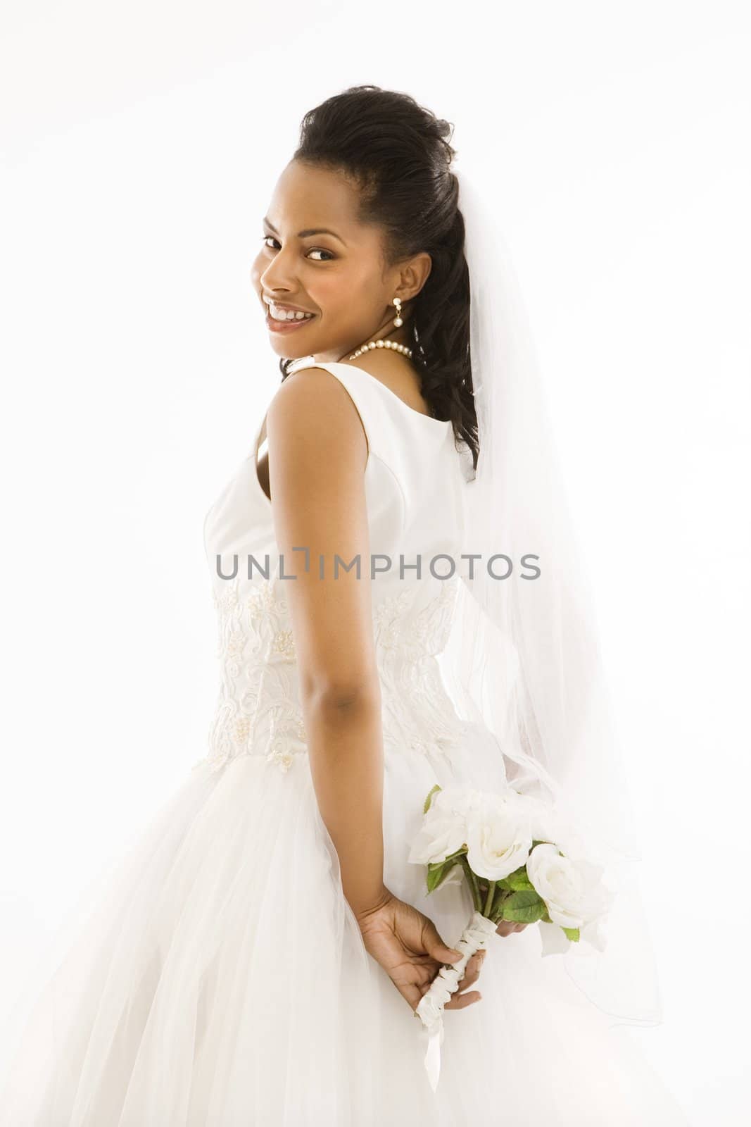 Portrait of a mid-adult African-American bride holding bouquet.