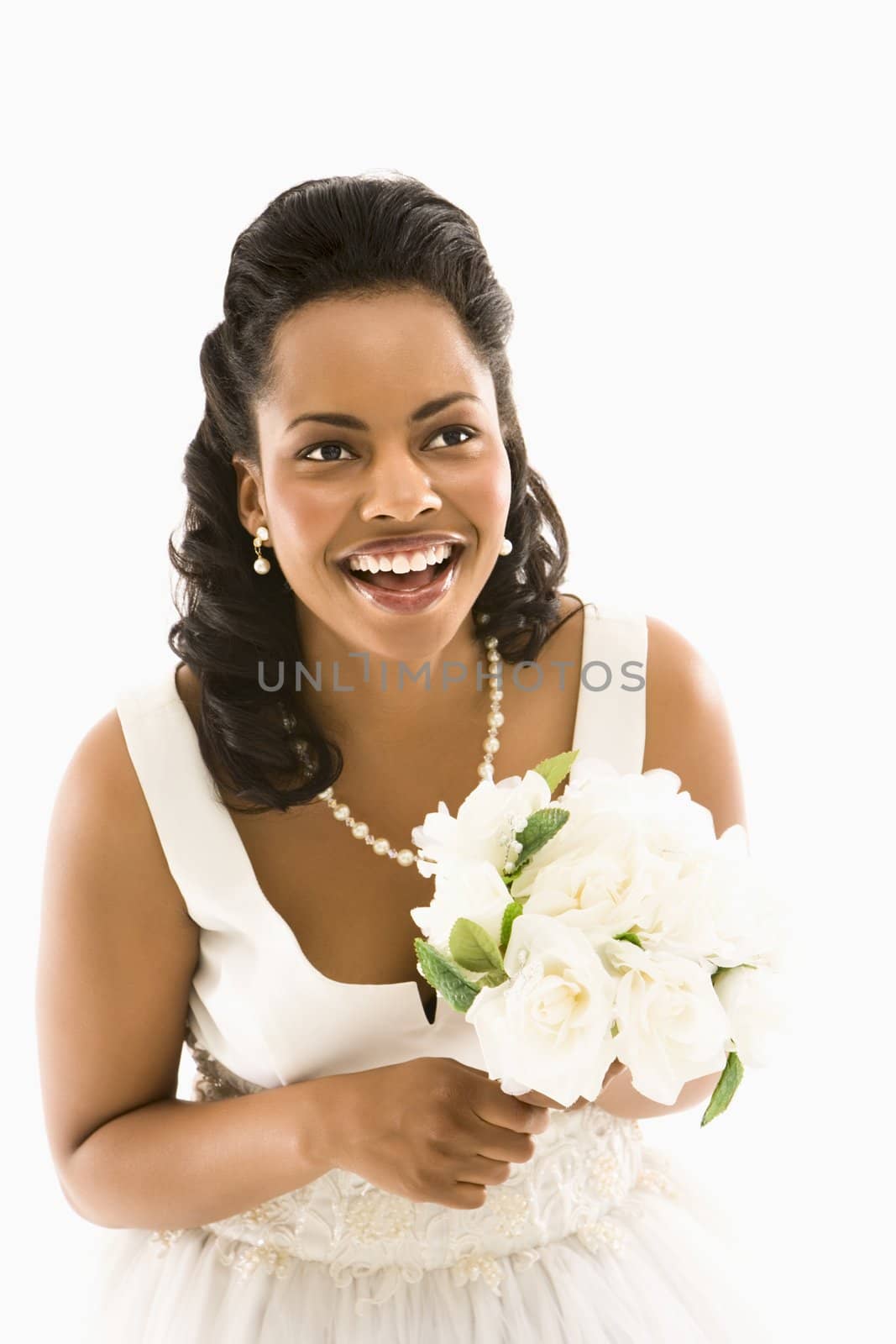 Portrait of a mid-adult African-American bride holding bouquet.