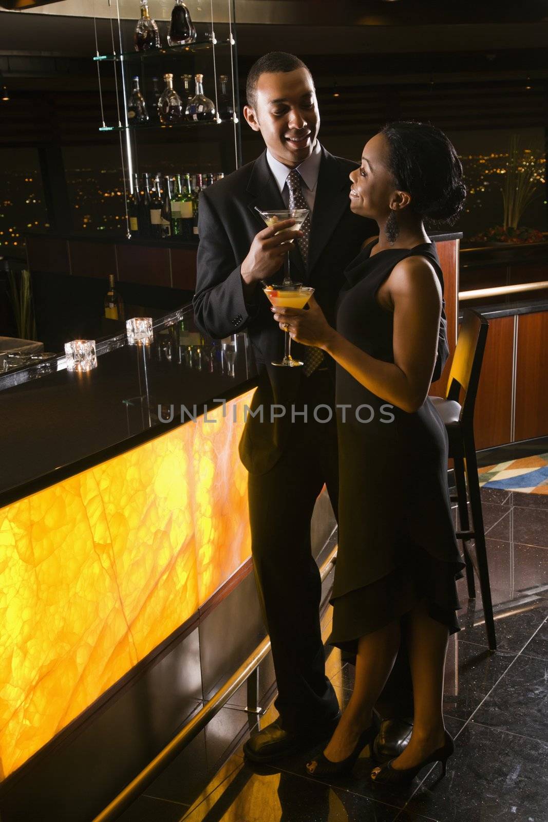 African-American couple having drinks at the bar.