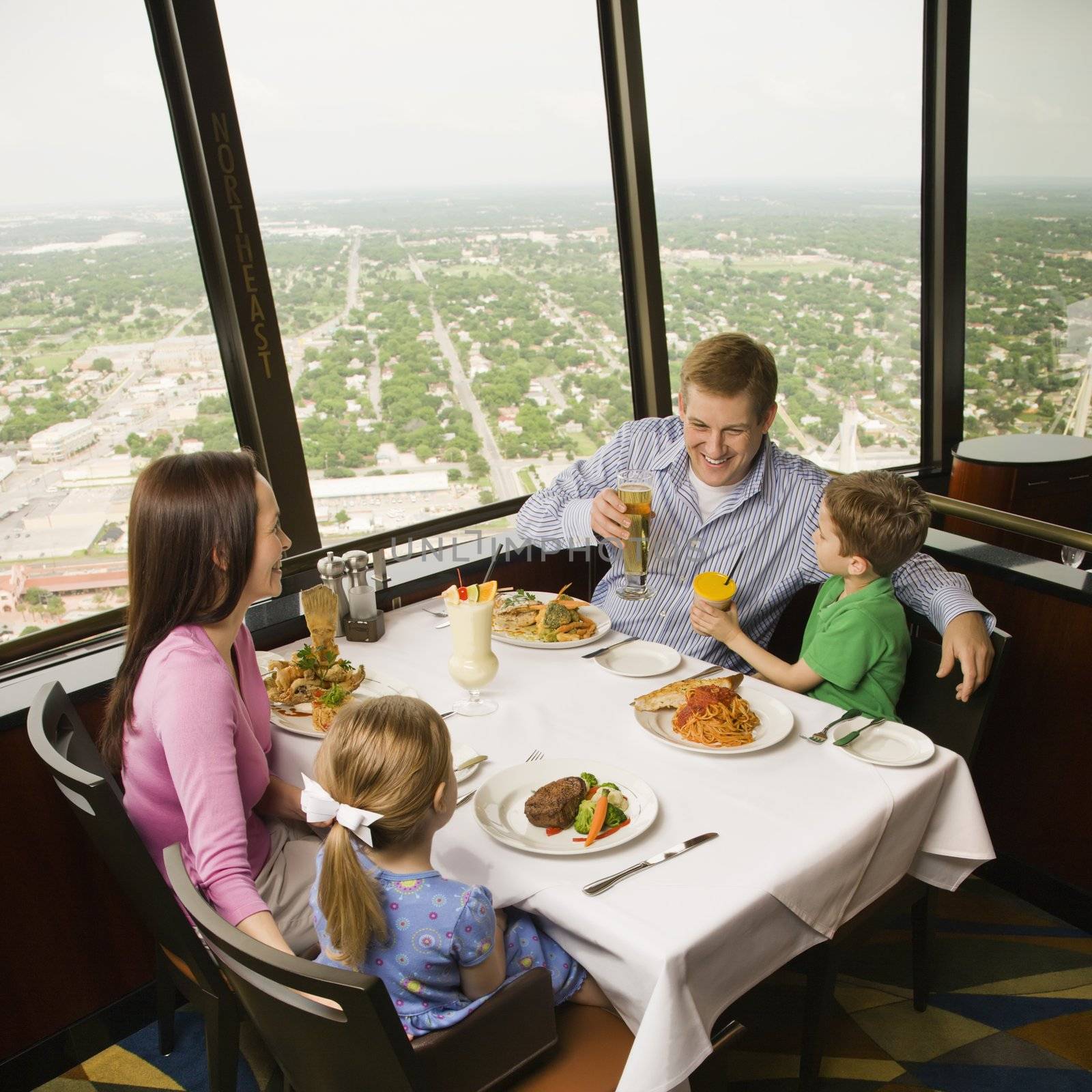 Caucasian family having dinner together at Tower of Americas restaurant in San Antonio, Texas.