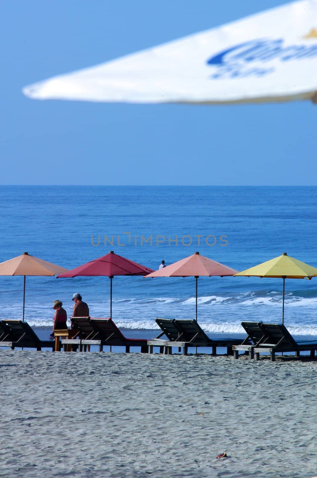 colorful beach umbrellas with seats