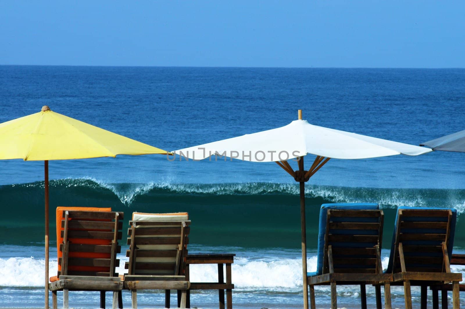 colorful beach umbrellas with seats