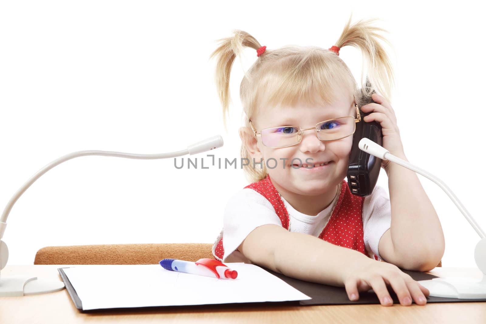 happy child at the table with pnone