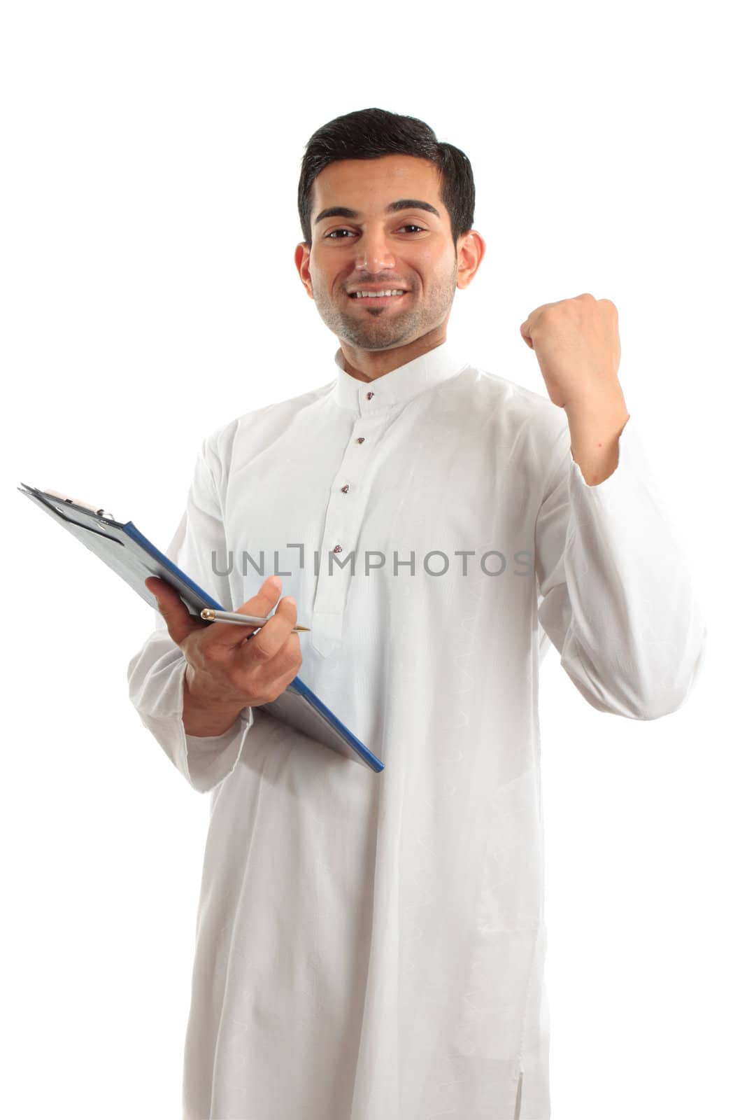 happy ethnic businessman wearing traditional robe, durta, dishdasha, holding a file folder and with hand clenched in a victorious fist.