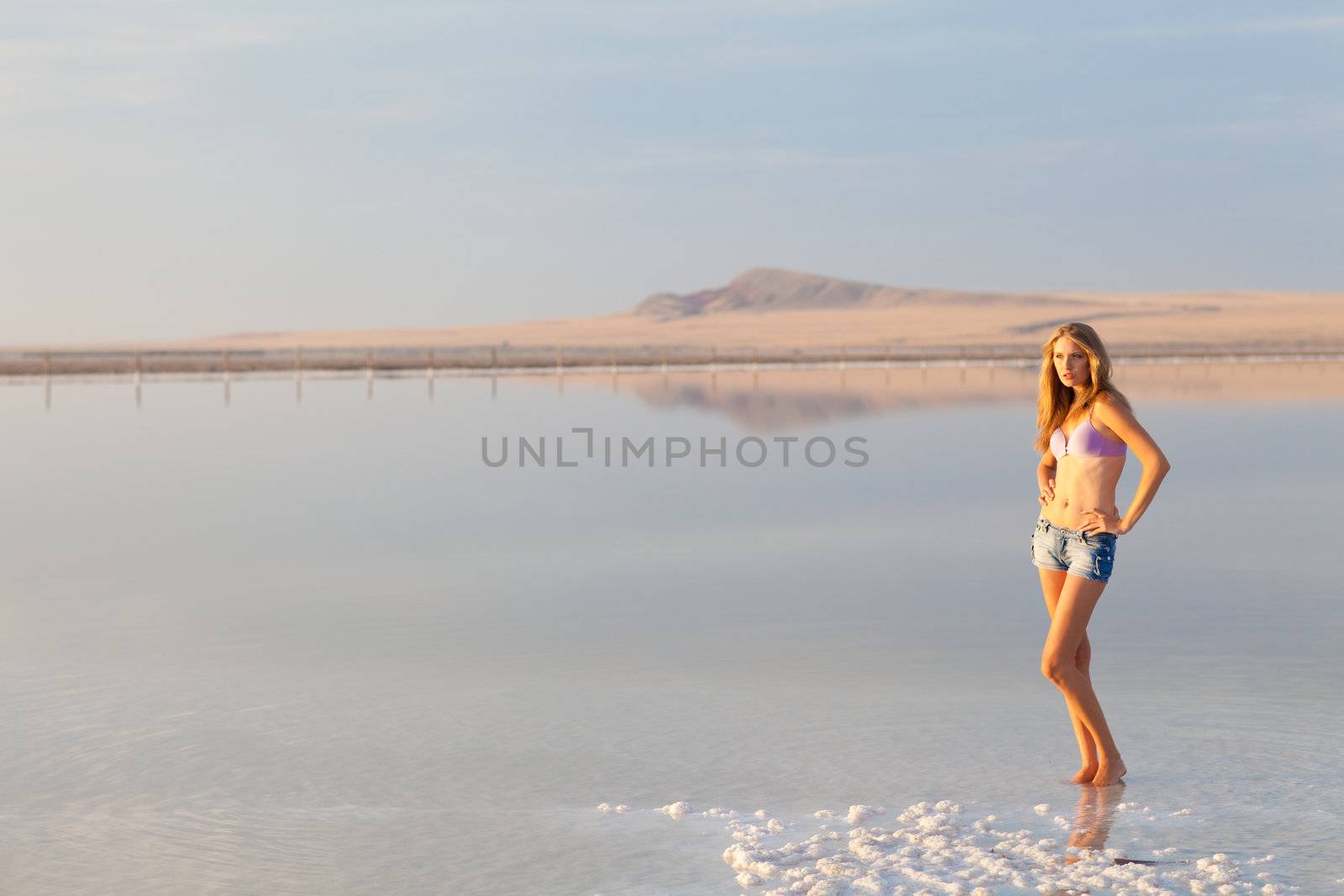 girl in a salt lake in a sunrise