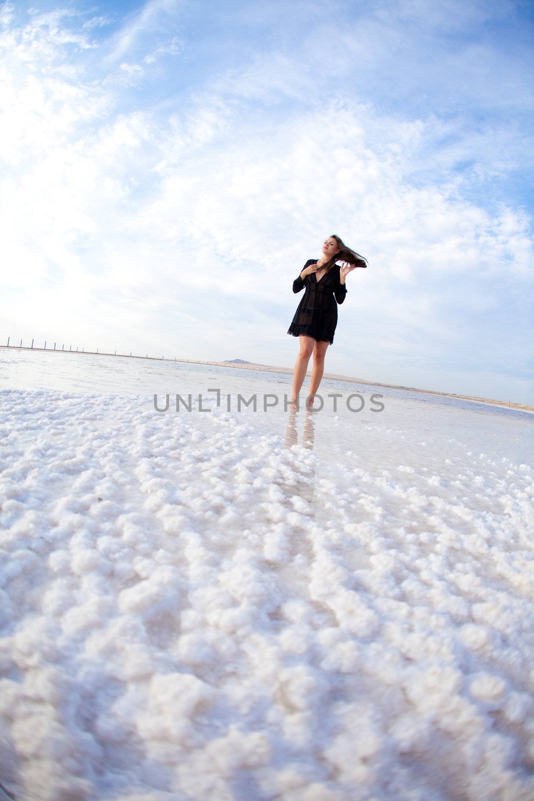 girl in a salt lake in a sunrise