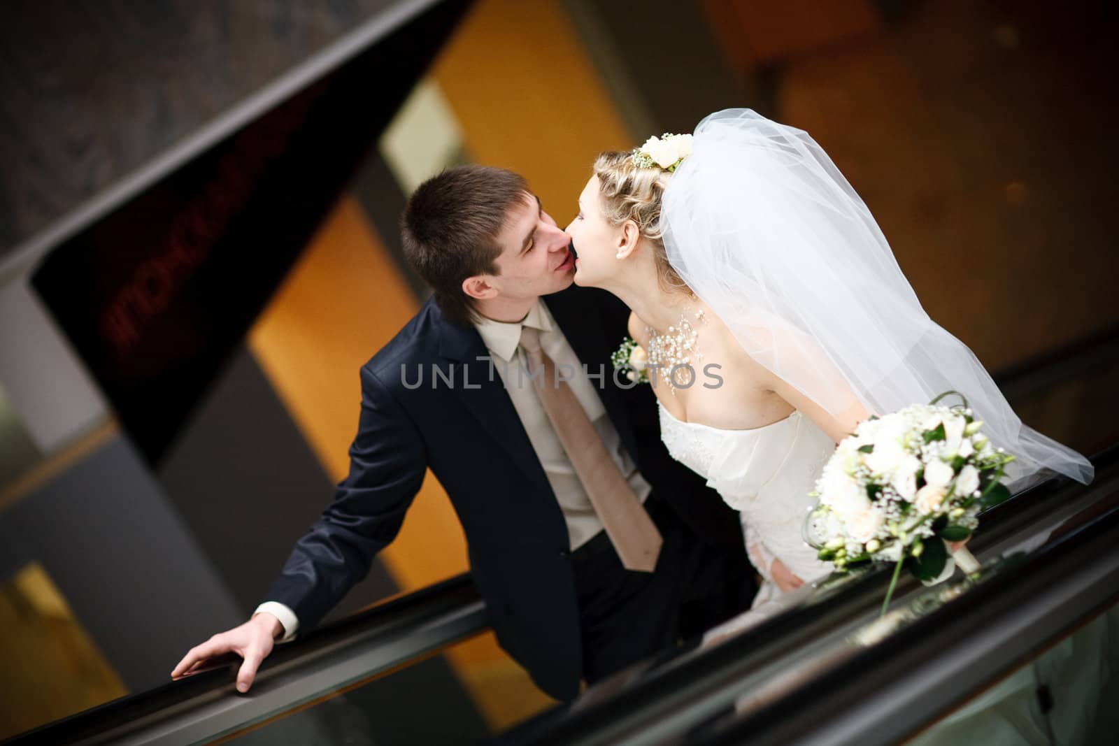 kiss of bride and groom in metro