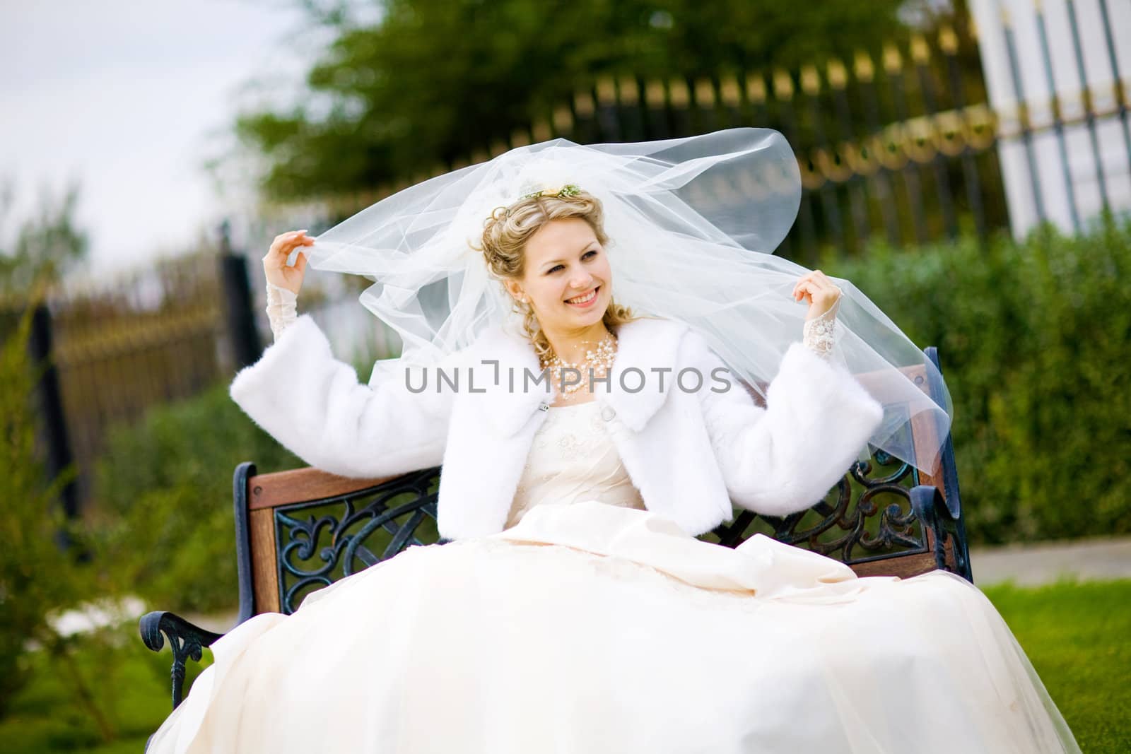 happy bride outdoors with veil