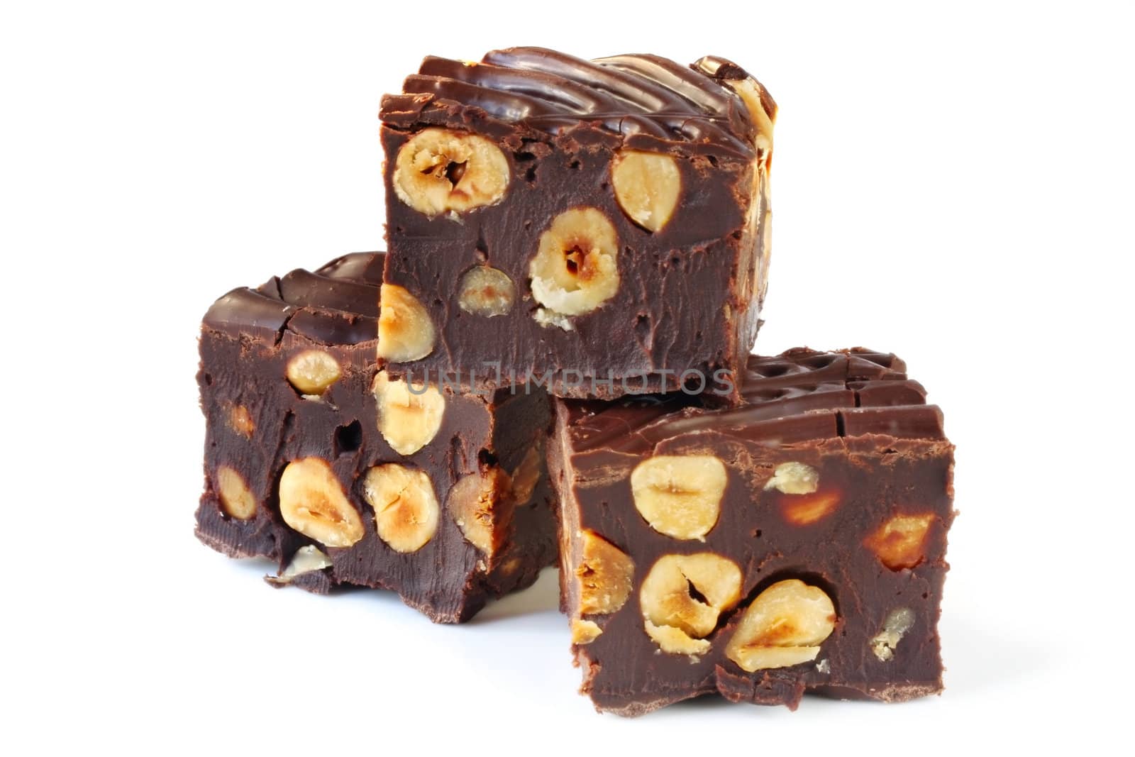 Chocolate fudge brownies with hazelnuts, isolated on white.