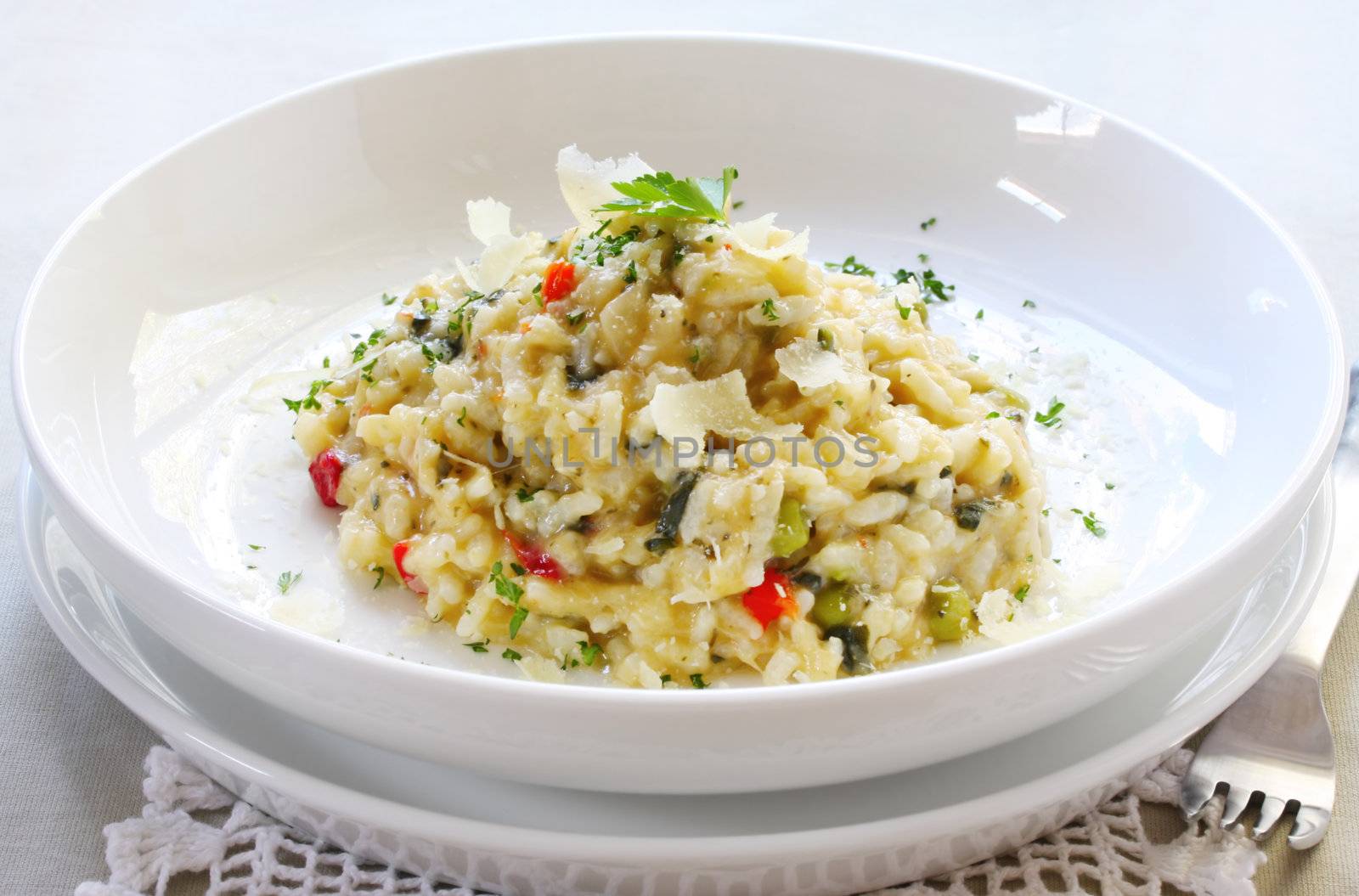 Chicken and garlic risotto, garnished with shaved parmesan and parsley.