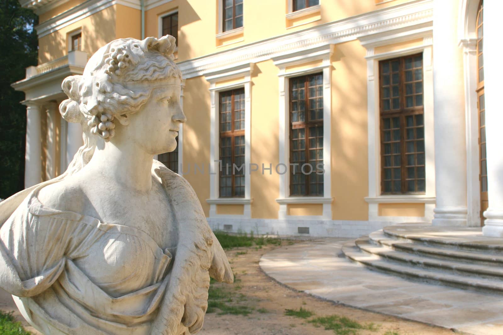Fragment of the Antique Sculpture, Feminine Figure on Background of the Building with Pillar