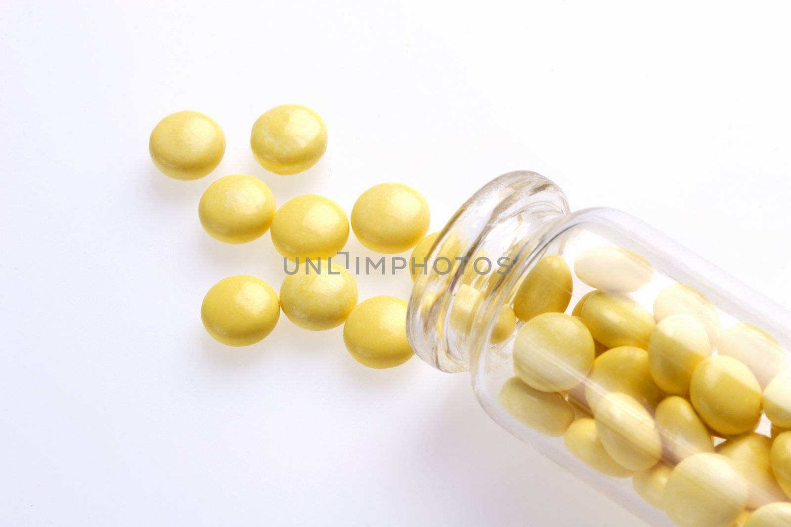 Yellow Capsules with Medicament near Vial