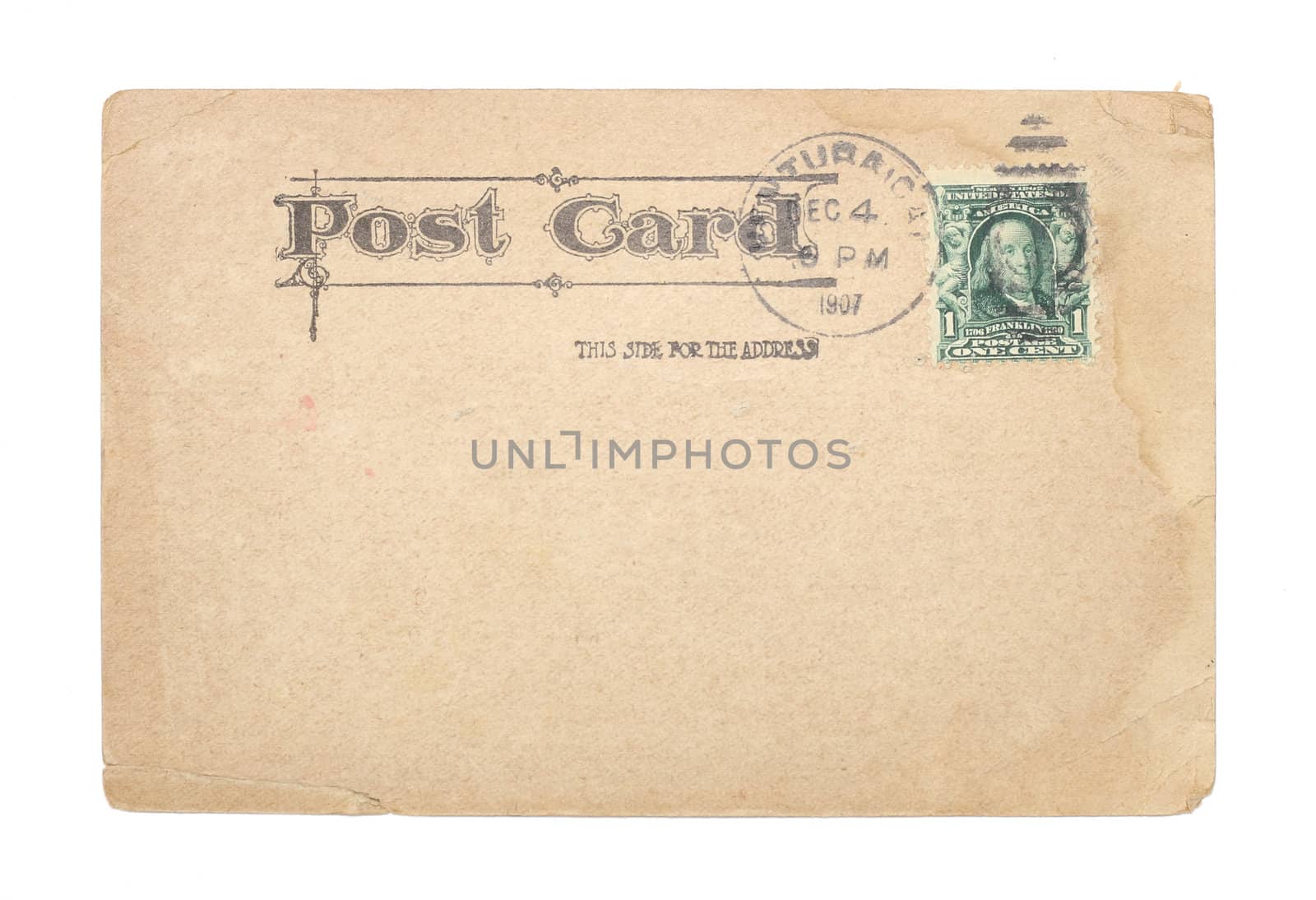 A blank, vintage United States postcard from 1907 with a green, cancelled, one-cent stamp. Post card shows water stains and creases.