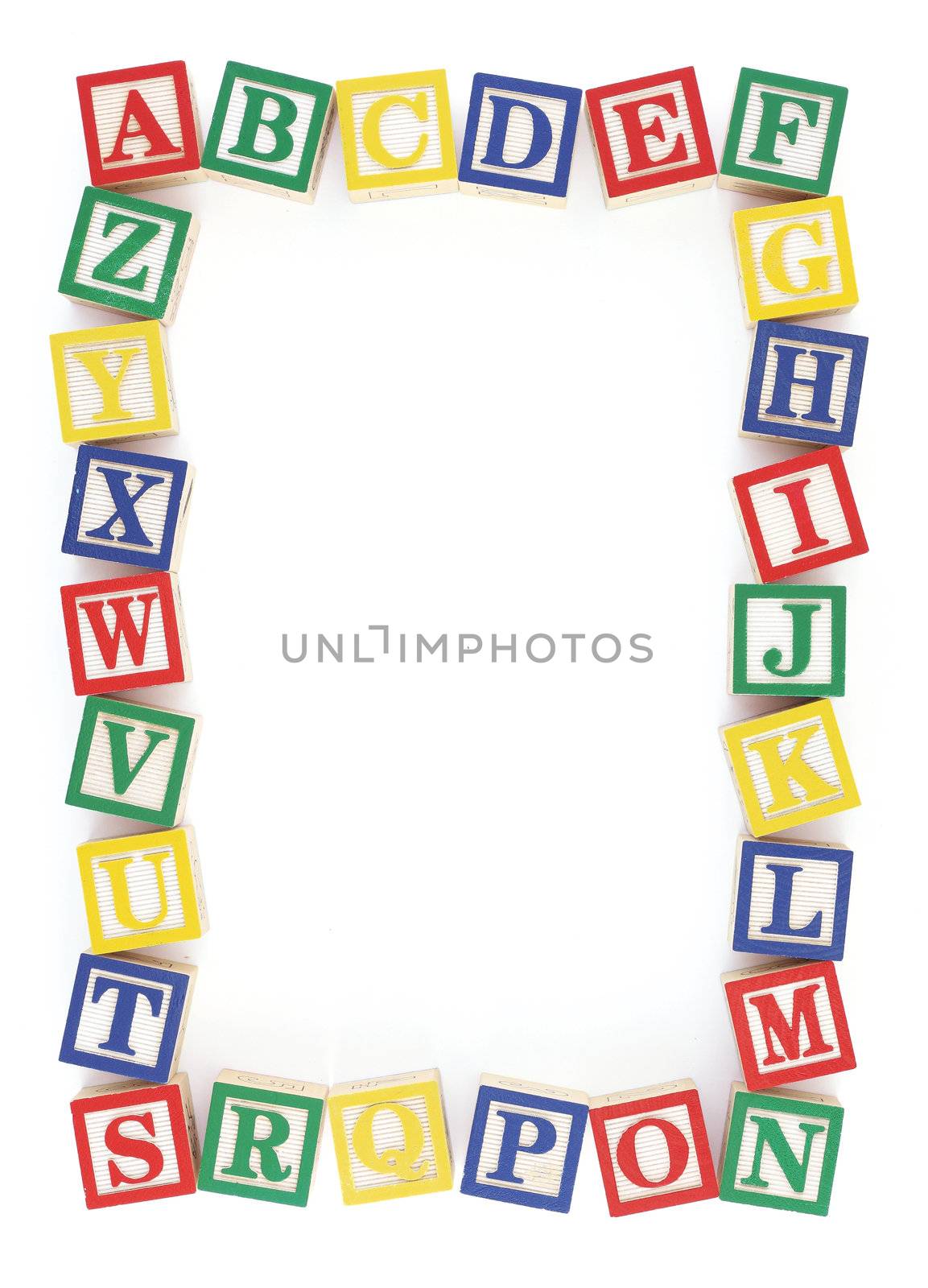 Wooden alphabet blocks arranged to create a frame on a white background