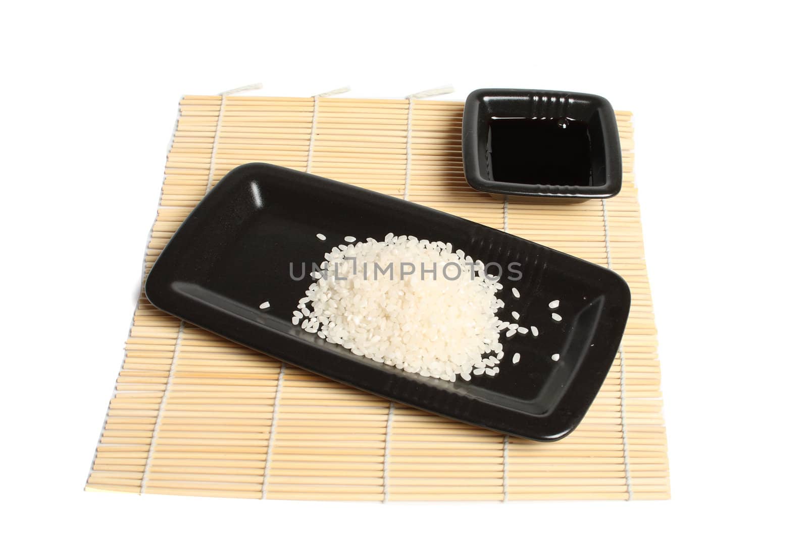 black plate with rice on the mat isolated over white