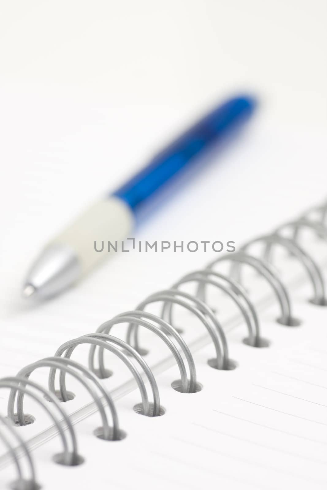 blue pen on spiral notebook