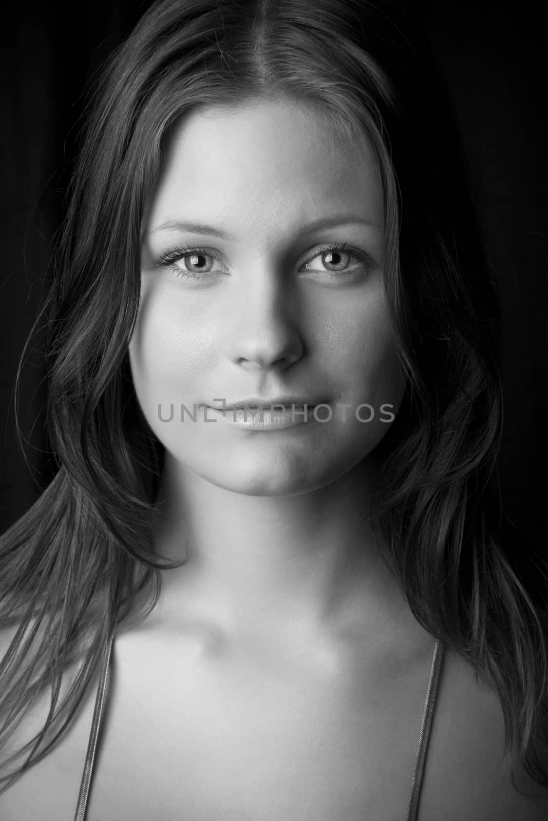 Portrait of young beautiful woman in black and white