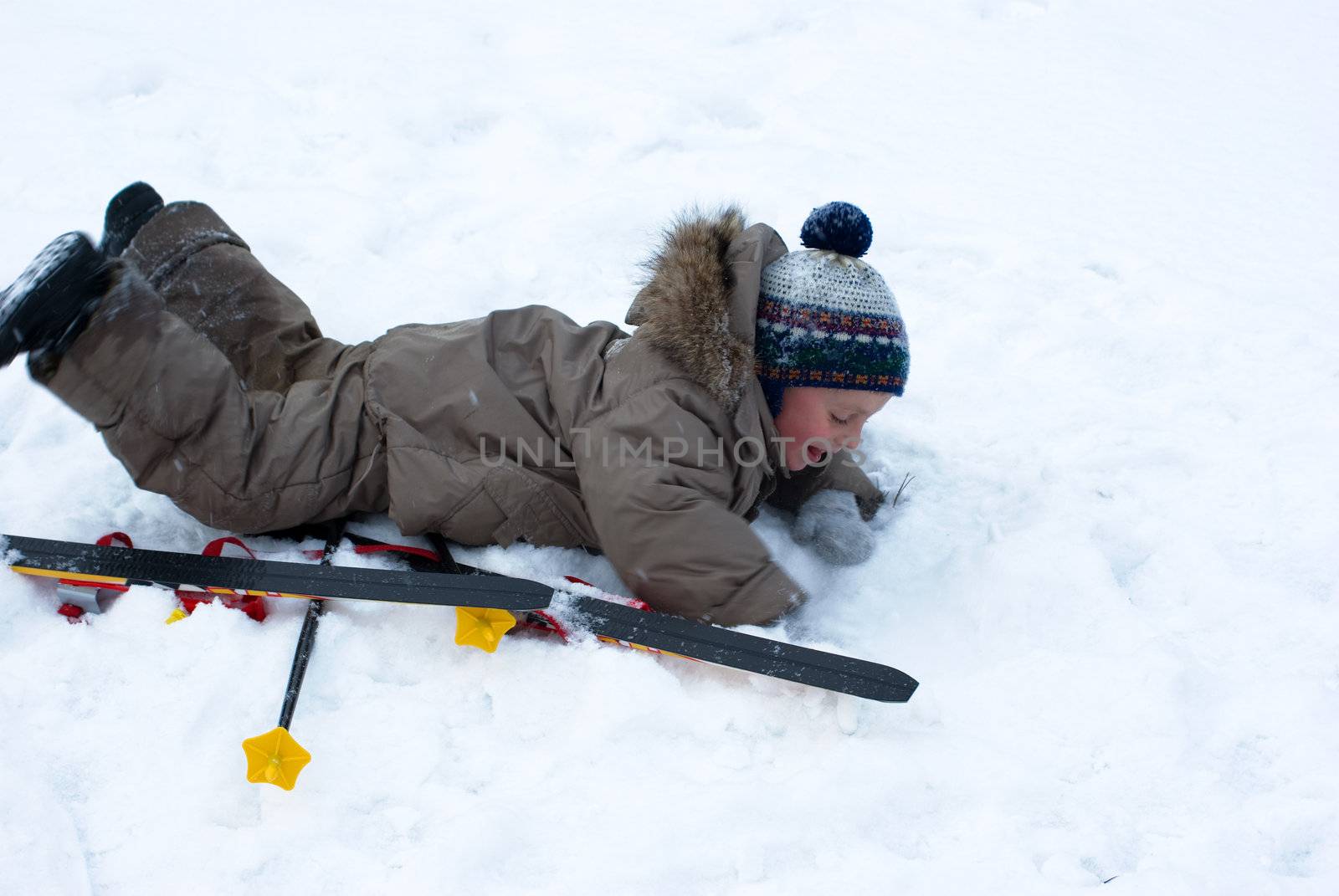 The boy laying on snow by kromeshnik