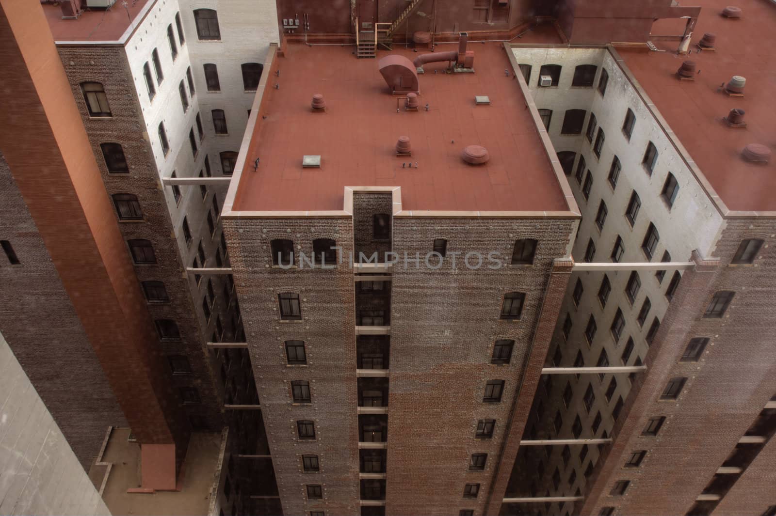 tall hotel building with a red roof, brick walls and steel reinforcements as seen from above