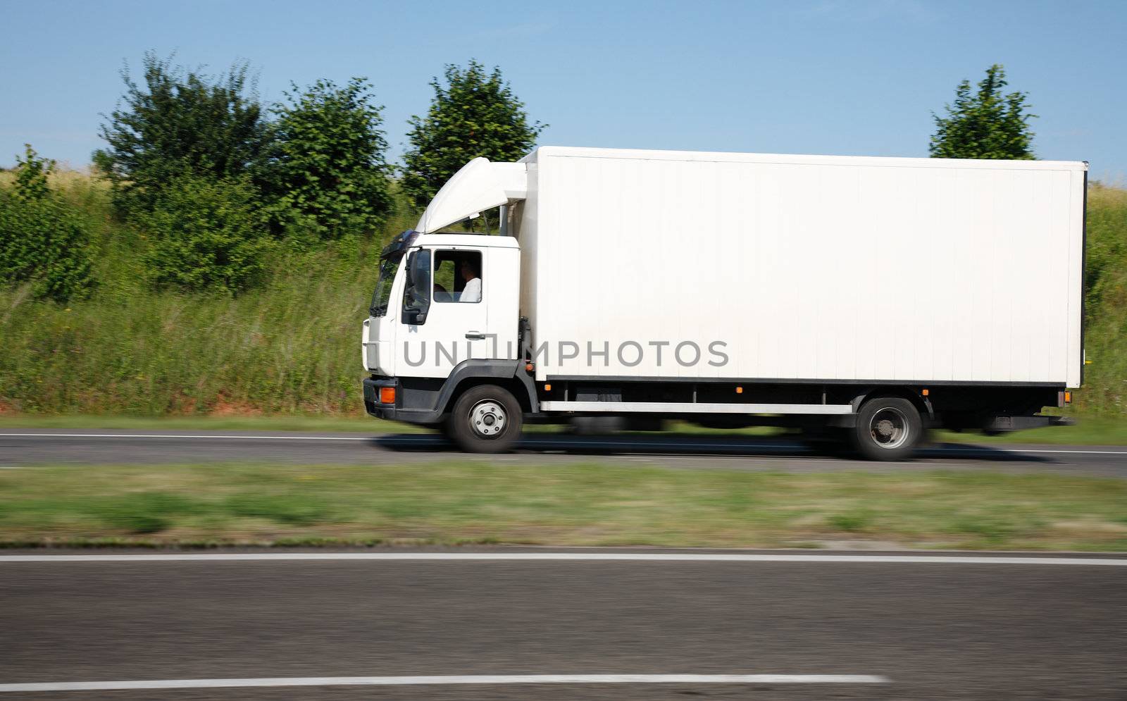 White truck speeding on freeway  by majeczka