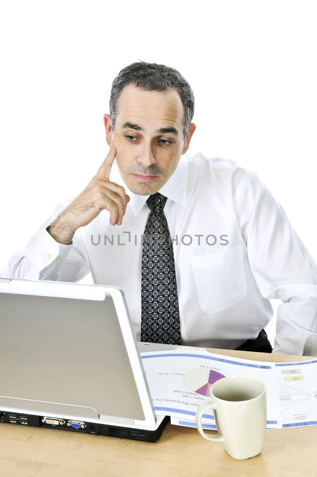 Thoughtful businessman sitting at his desk isolated on white background