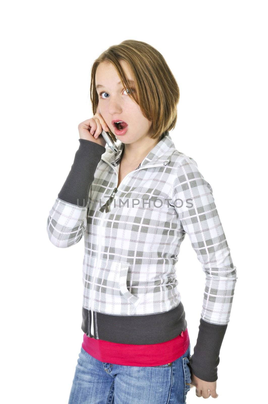 Teenage girl talking on a cell phone acting surprised isolated on white background