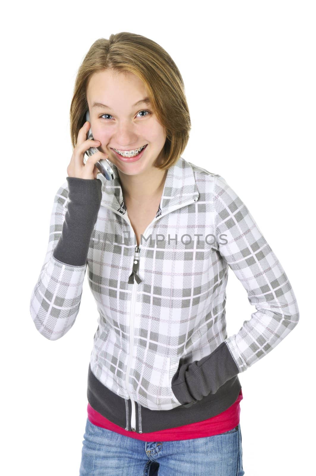 Teenage girl talking on a cell phone isolated on white background