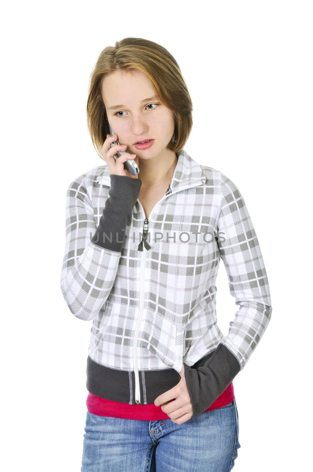 Teenage girl talking on a cell phone isolated on white background