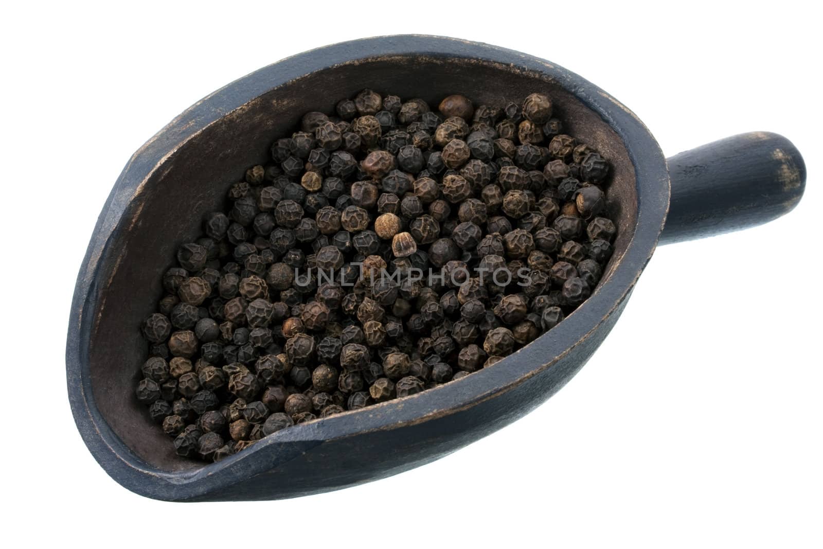 black peppercorns on a rustic, wooden scoop, isolated on white