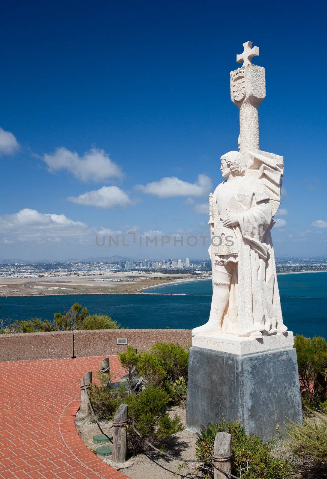 Skyline of San Diego in background behind statue of Cabrillo on Point Loma
