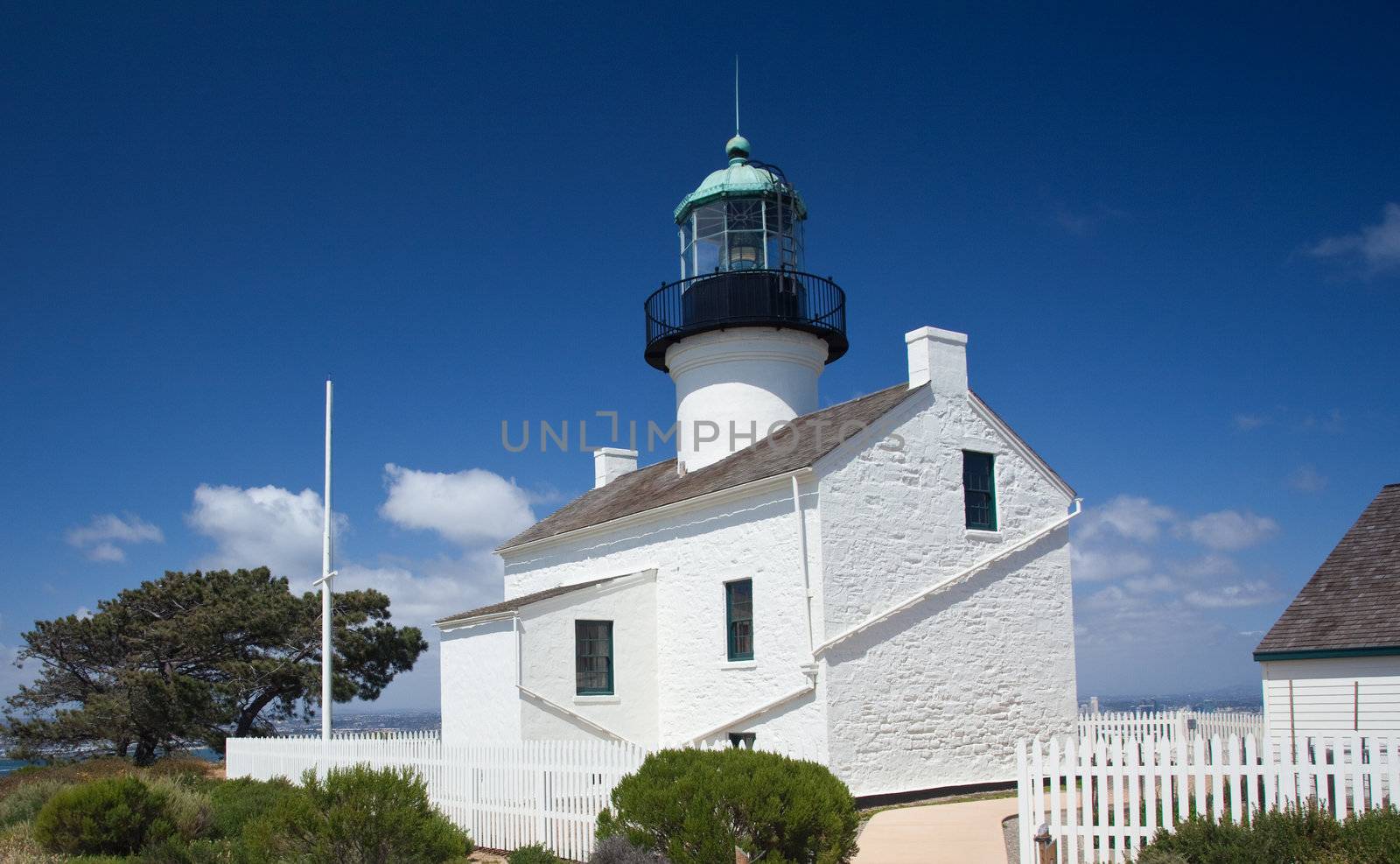 Old lighthouse on Point Loma near San Diego with a bright blue sky framing the shot