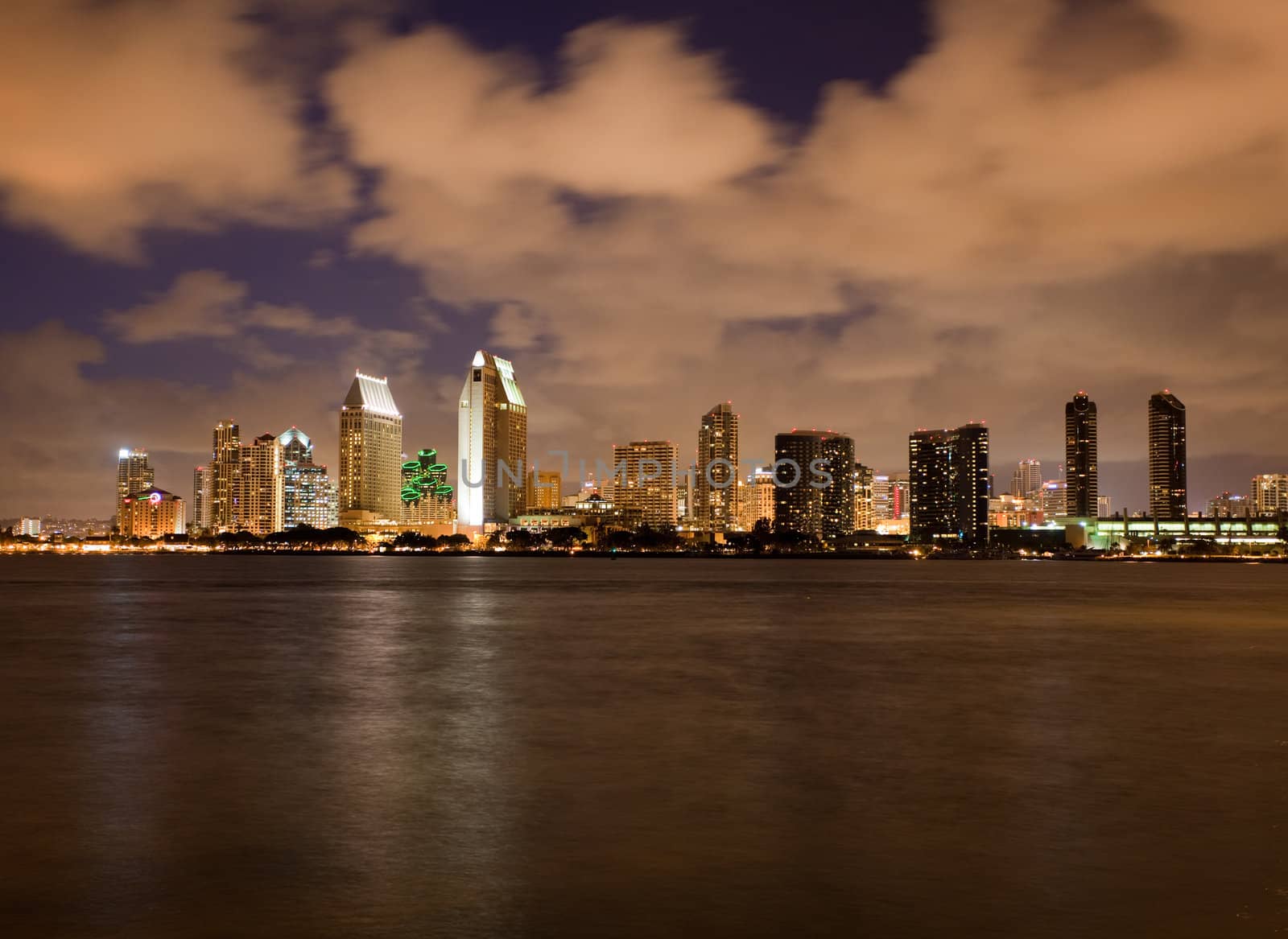 Sunset on San Diego skyline with city lights reflected in clouds taken from Coronado