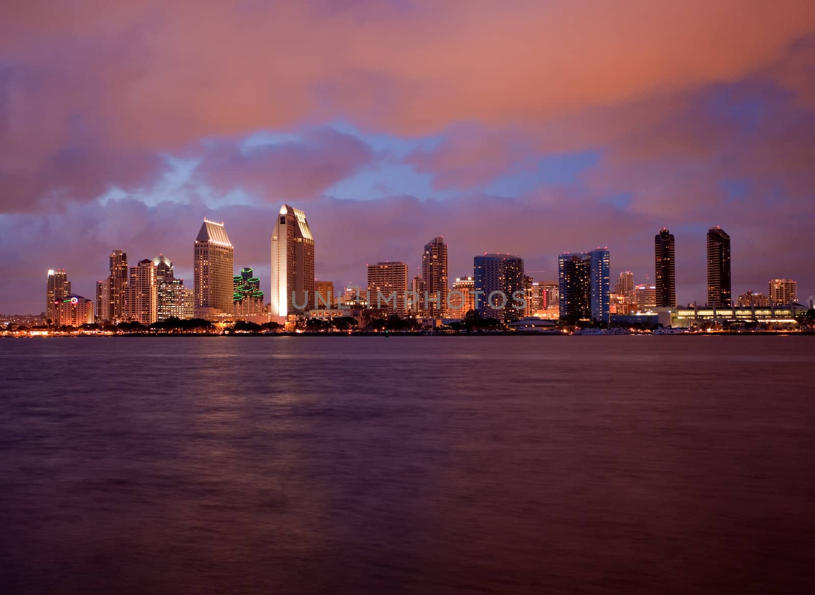 Sunset on San Diego skyline with city lights reflected in clouds taken from Coronado