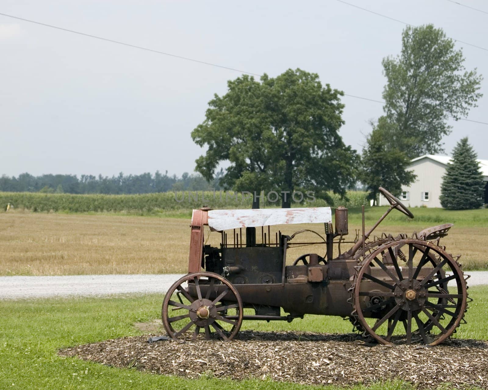 A very old antique tractor rusting away.