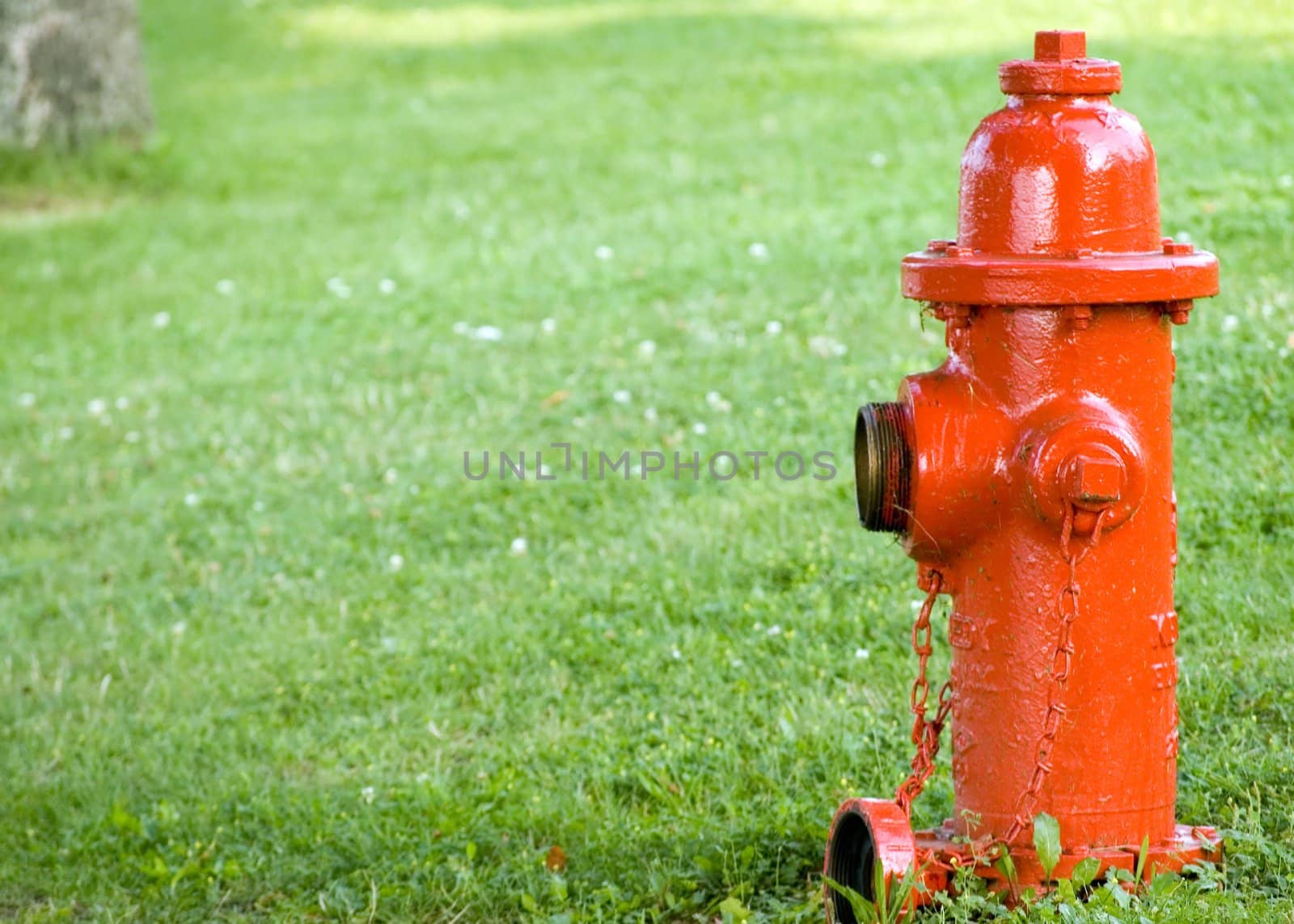 A red fire hydrant with a cap off.
