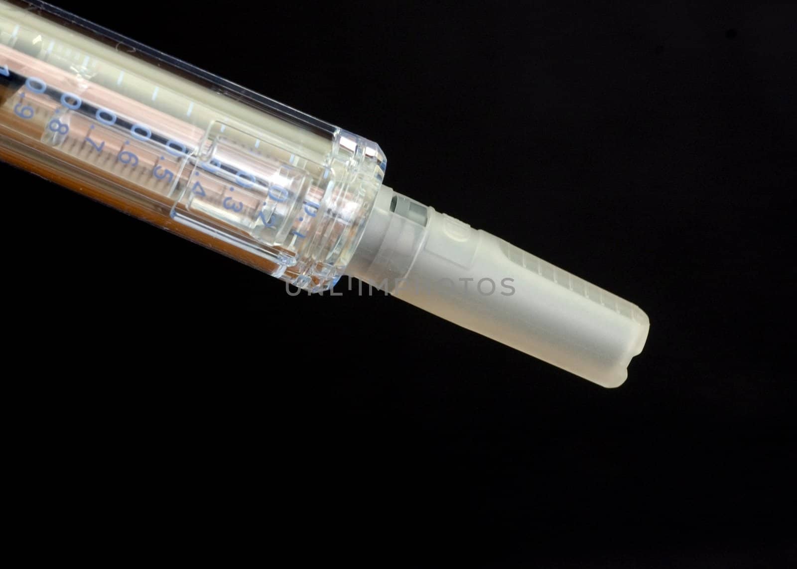 A close-up shot of a capped hypodermic needle.