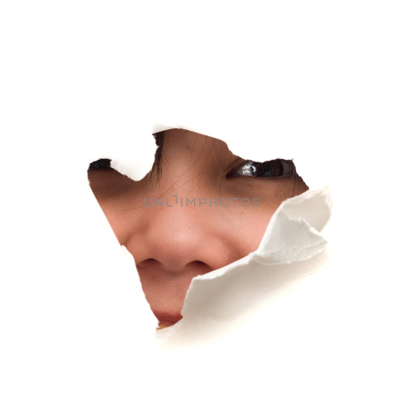 A childs face looking through a hole, isolated against a white background