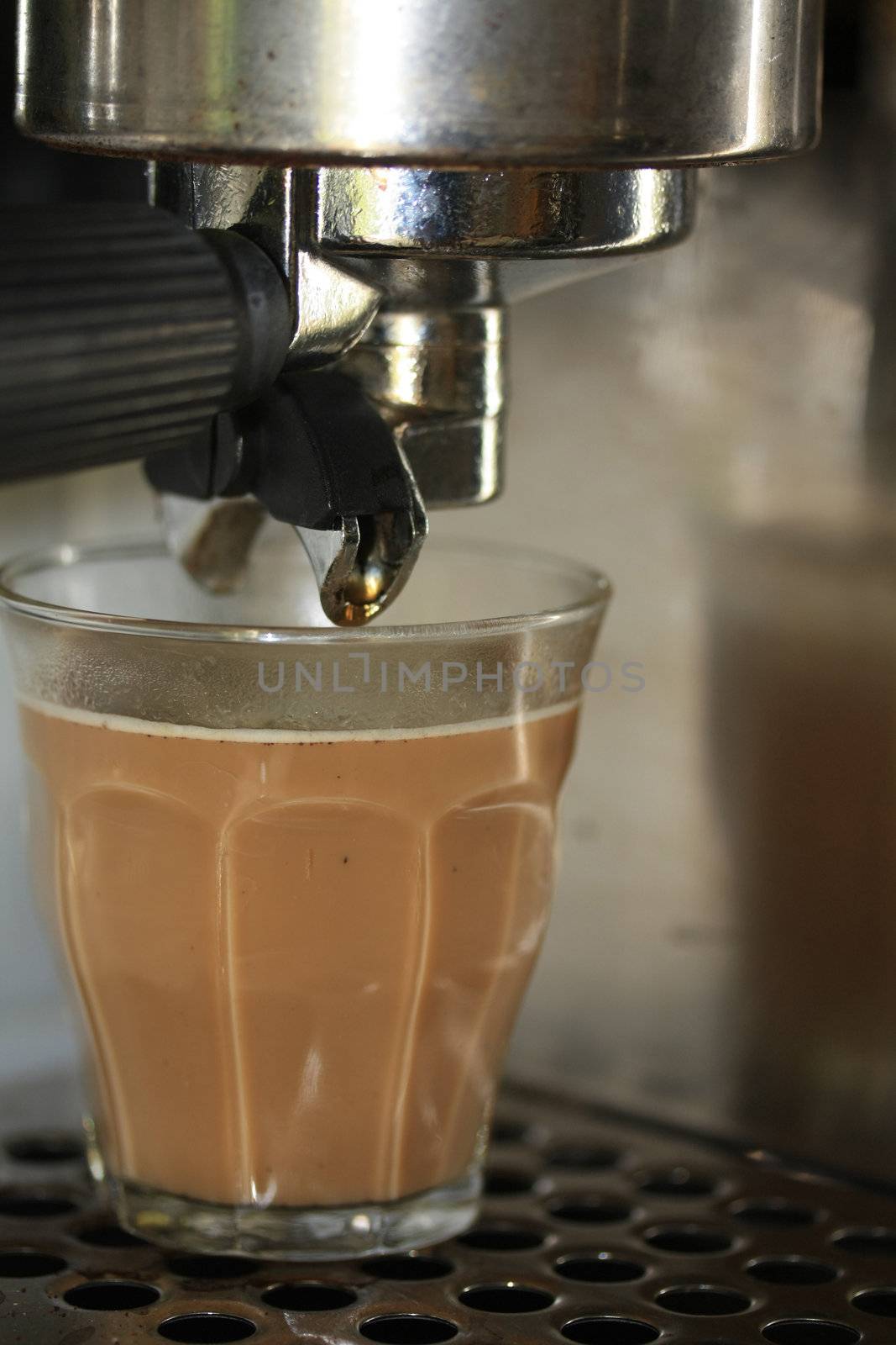 Latte macchiato under an espresso maker by studioportosabbia