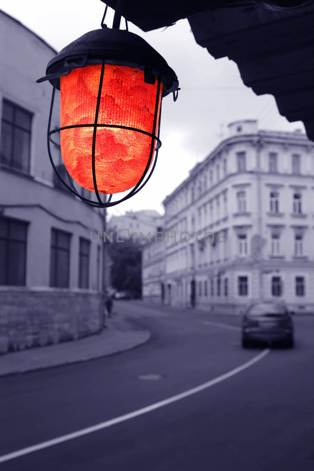 evening on old blue town street with red torch