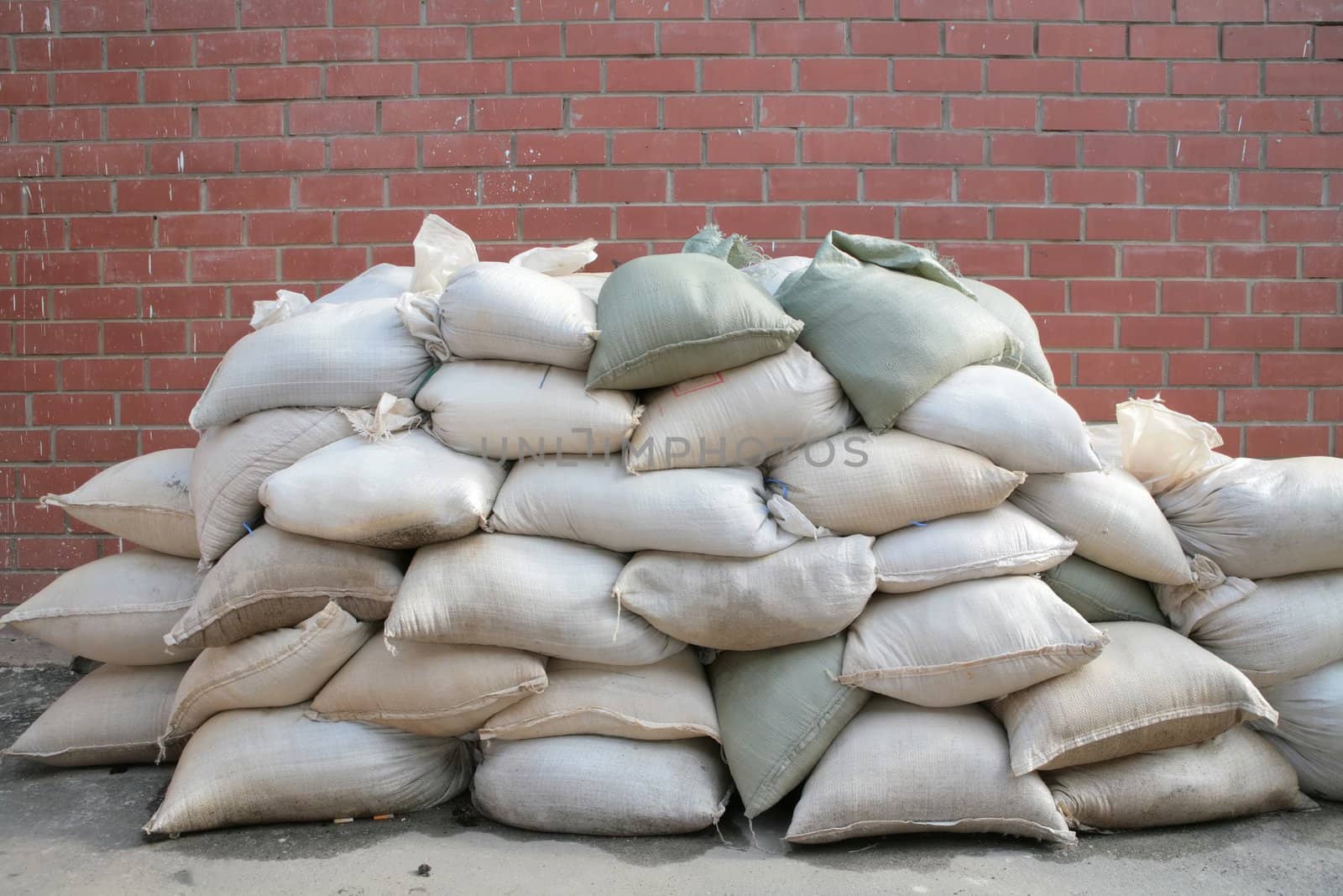 background, pervaded bags, liing stack near by brick wall