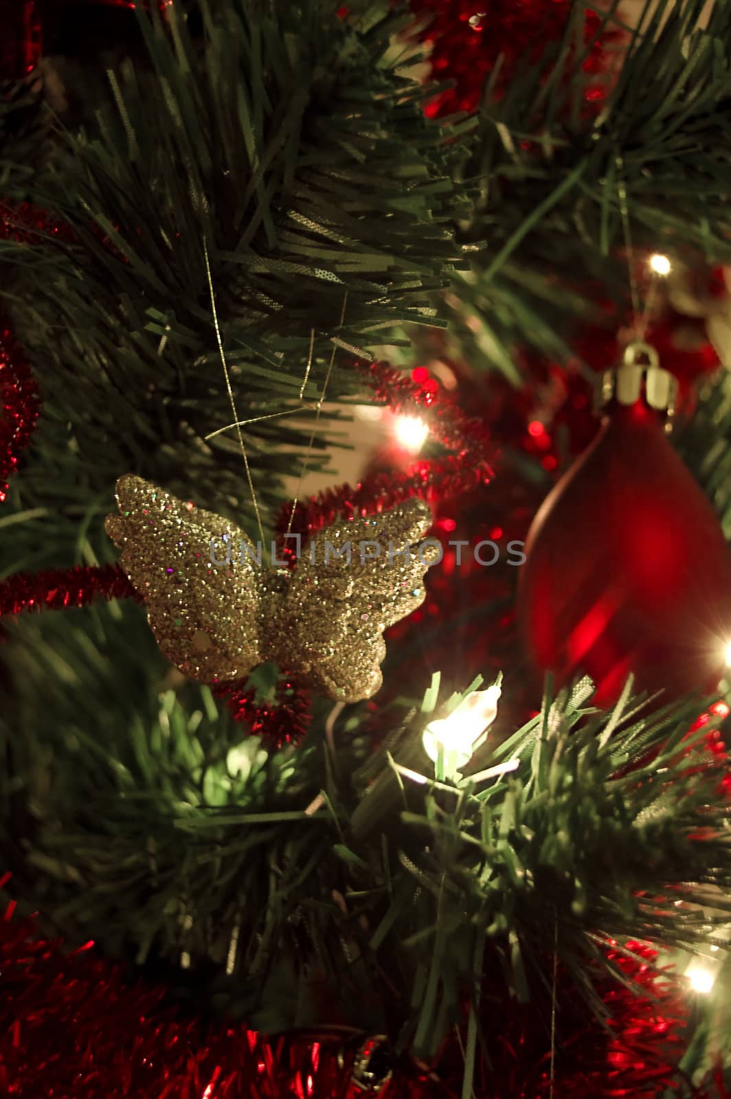 golden butterfly and christmas decoration hanging on tree
