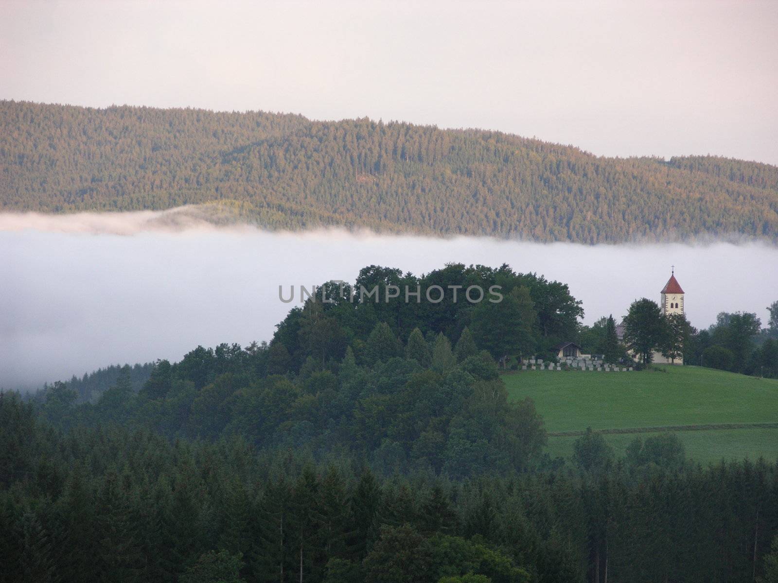 Morning in the mountains in Bavaria with a church in the background