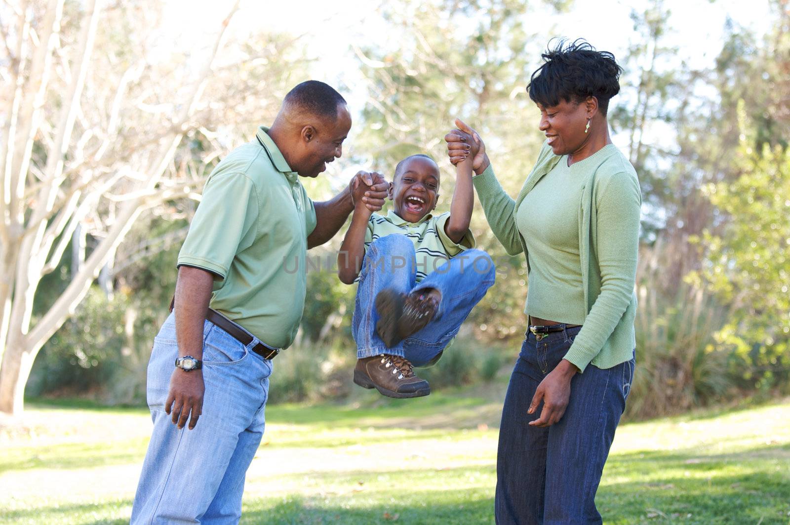 Man, Woman and Child having fun in the park.