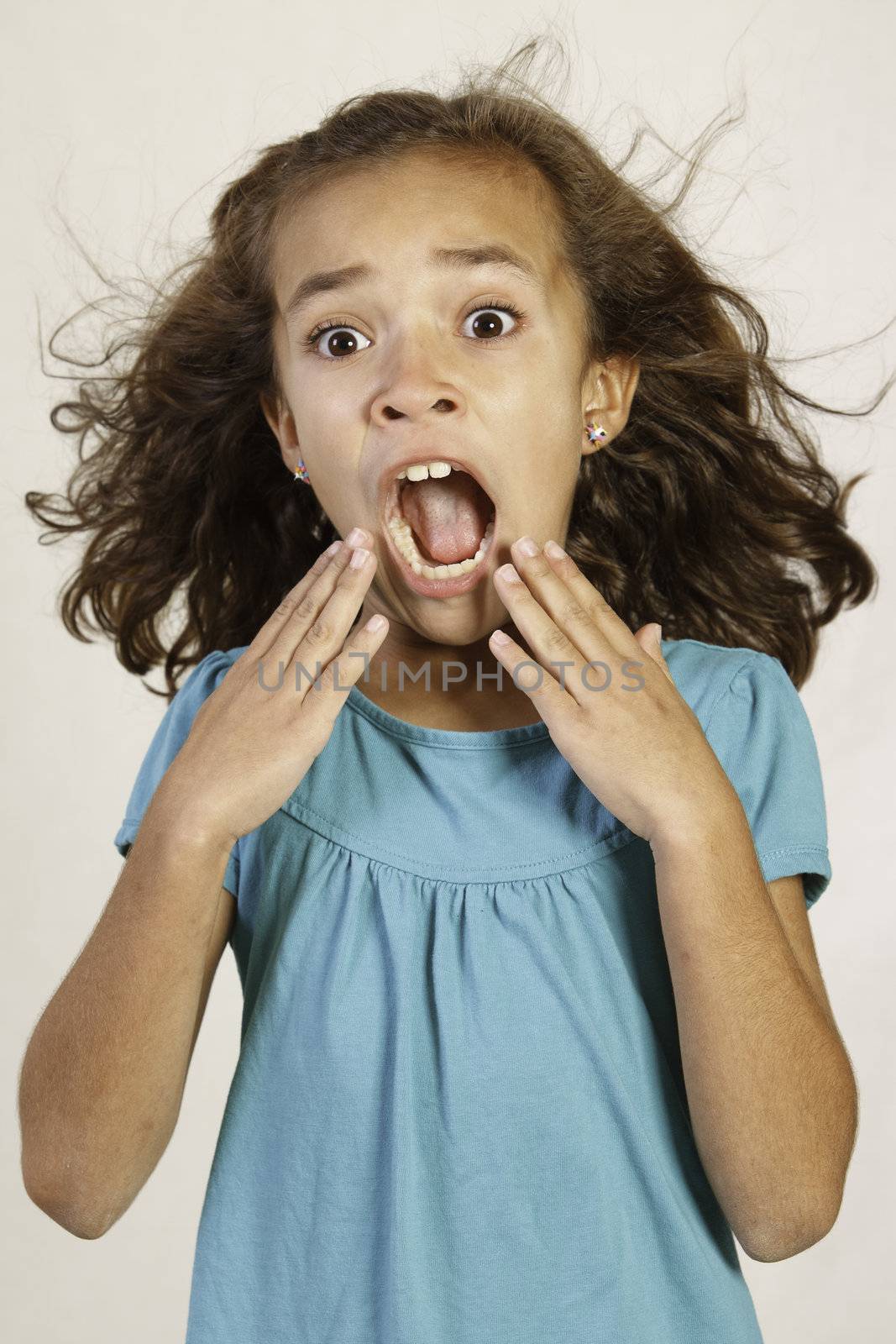 Cute Hispanic girl with shocked expression