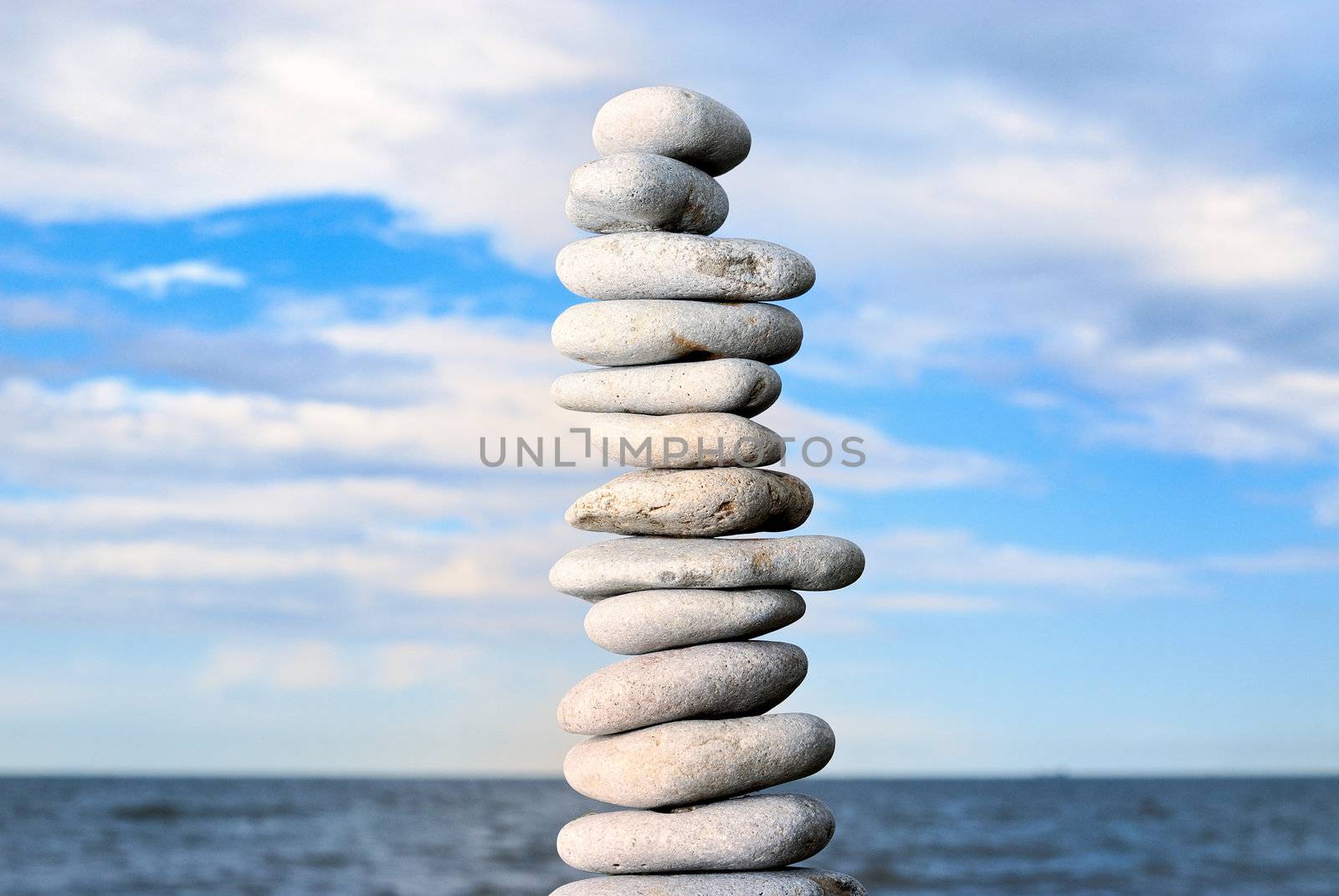 Grey stone tower on a beach by styf22