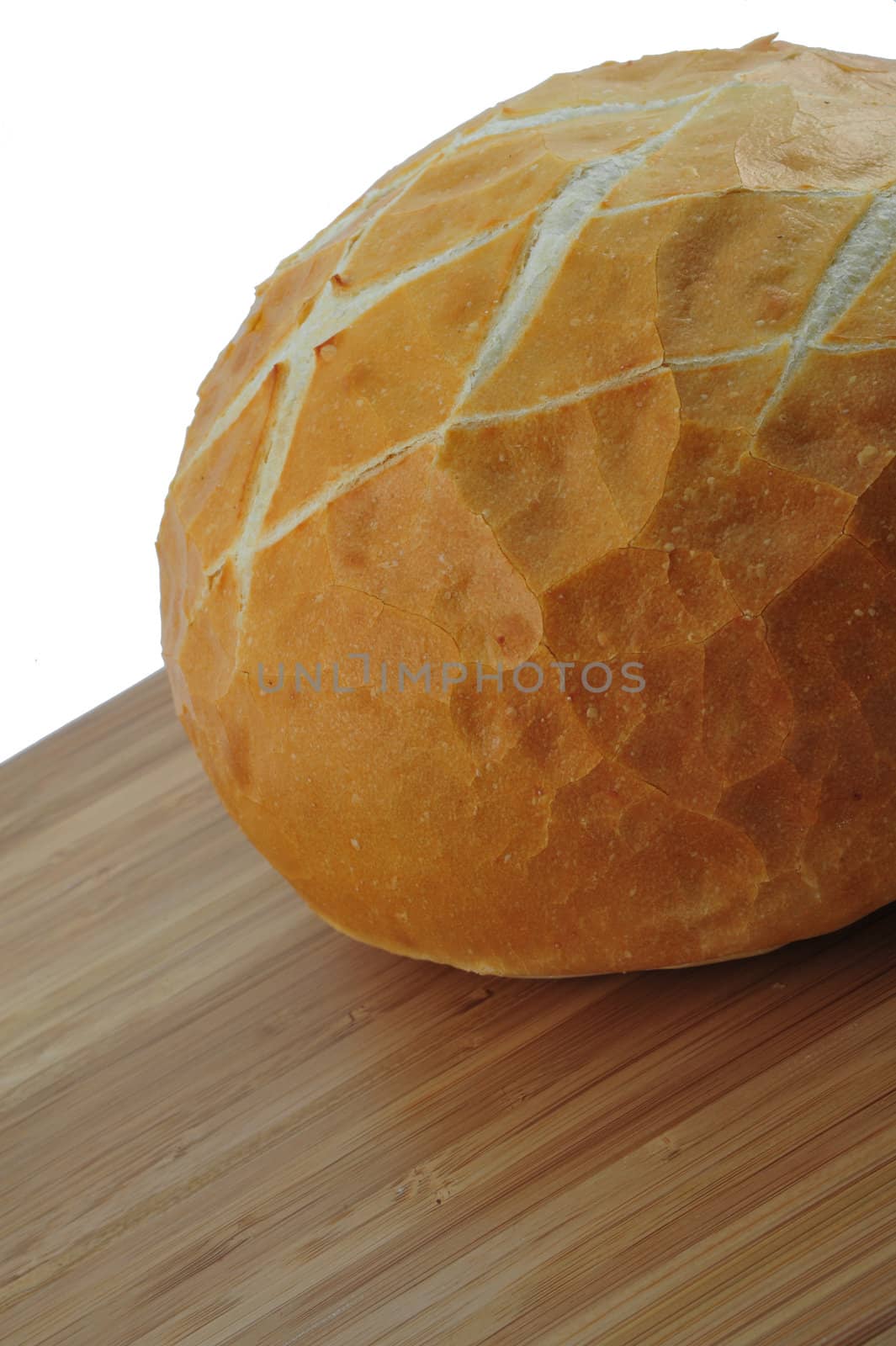 Round loaf of fresh sourdough bread on a cutting board