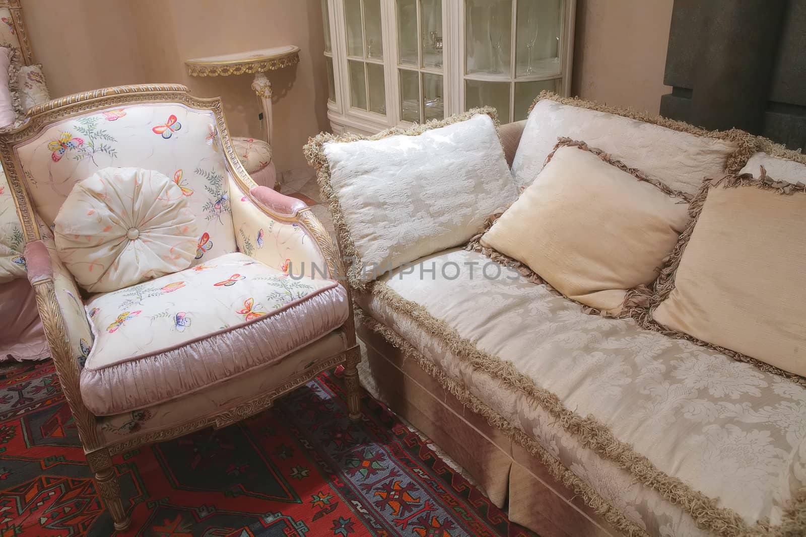 fragment of the luxurious interior with sofa and armchair in rococo style, soft furniture