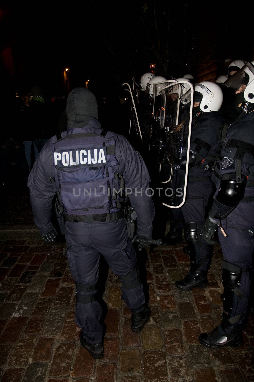 Agresive crowd and police near Latvian Parliament. Riga, Latvia, January 13, 2009