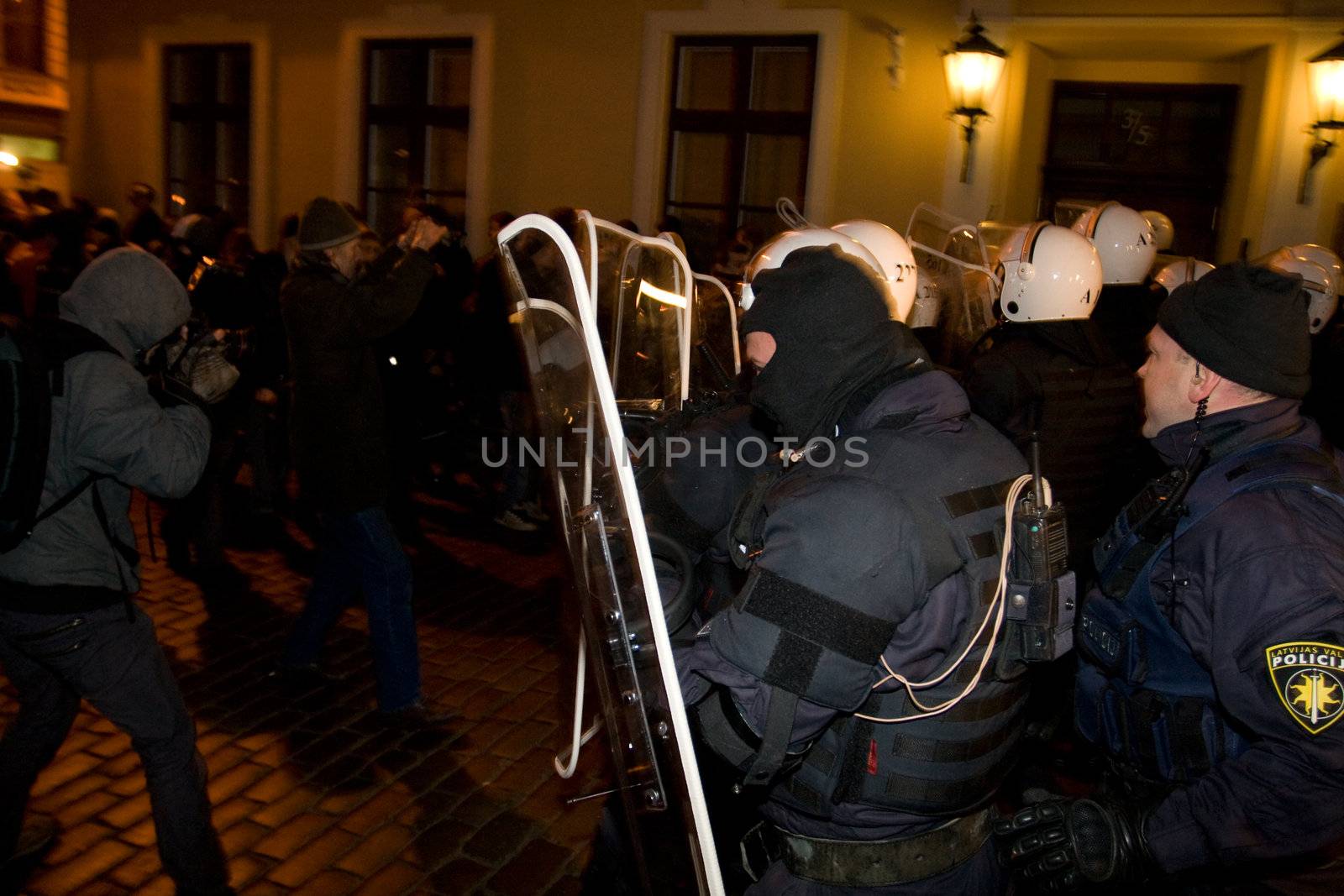 Agresive crowd and police near Latvian Parliament. Riga, Latvia, January 13, 2009